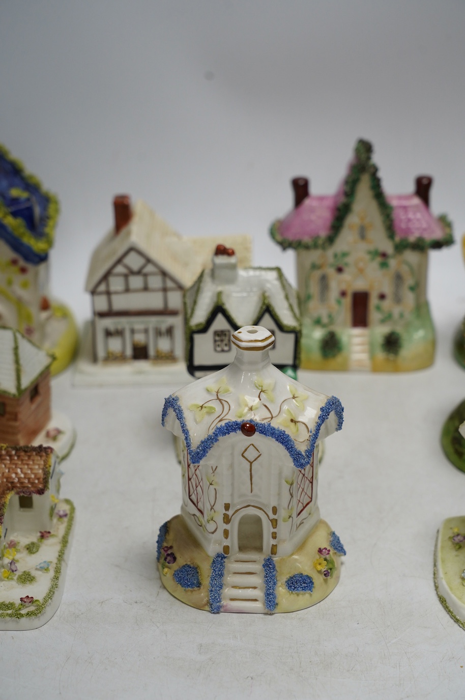 Ten various ceramic model cottages. Condition - fair to good